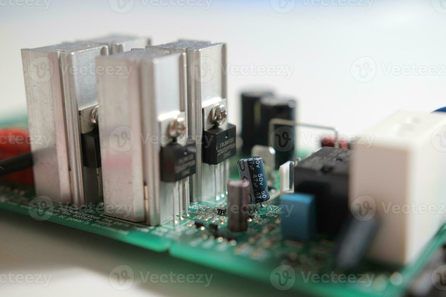 Power Supply modern printed-circuit board with electronic components with transistor. PCB detail photo
