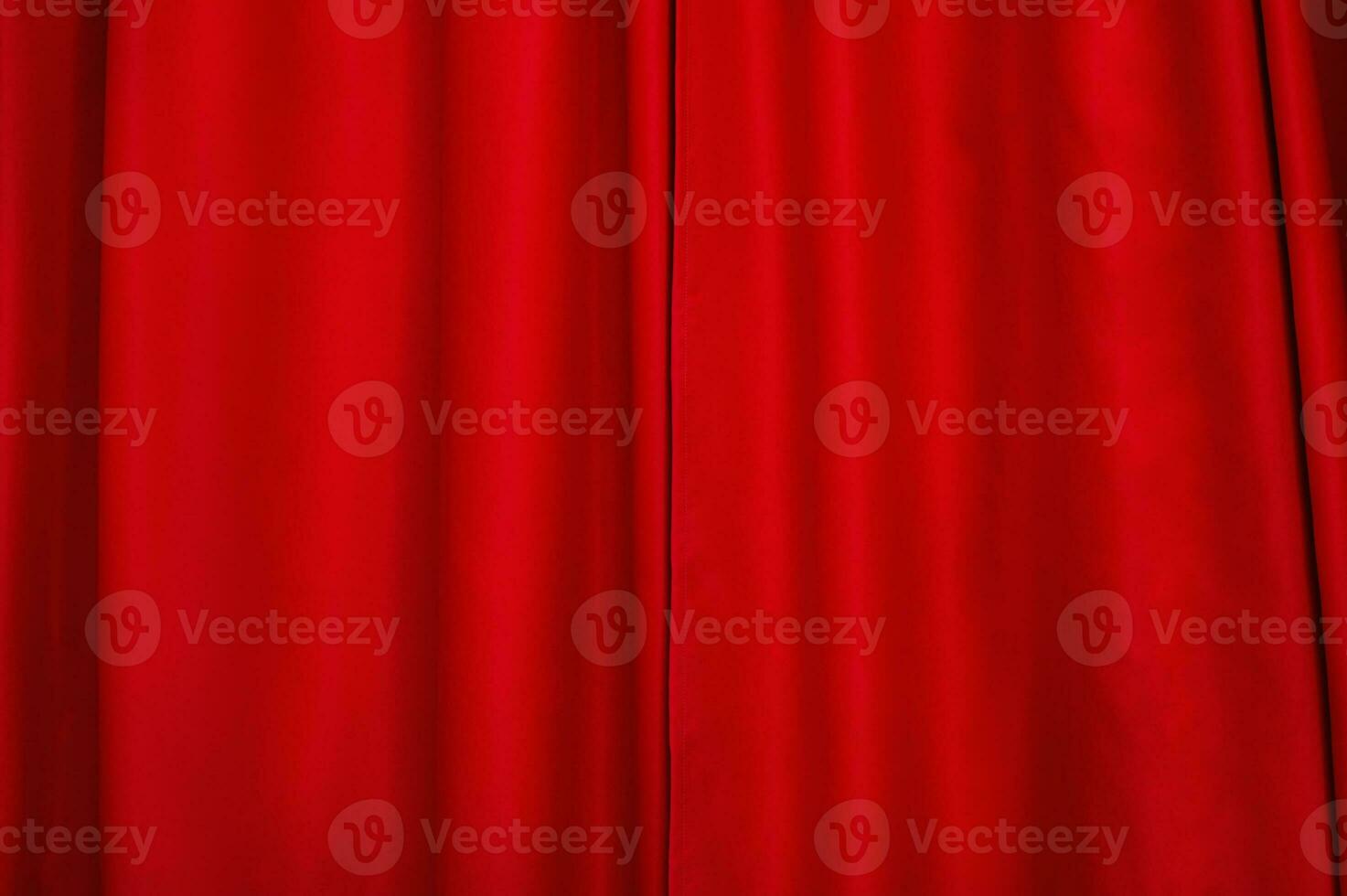 Red fabric as a background. Red light-absorbing curtain. The window is closed with a curtain. photo