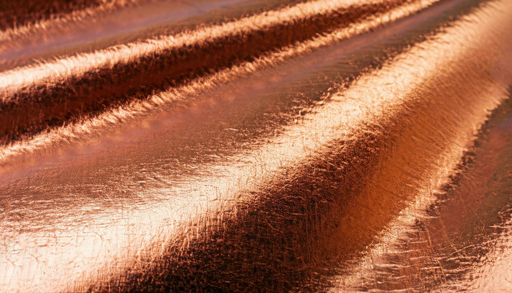 macro photo of copper surface of metal smooth foil with metal texture