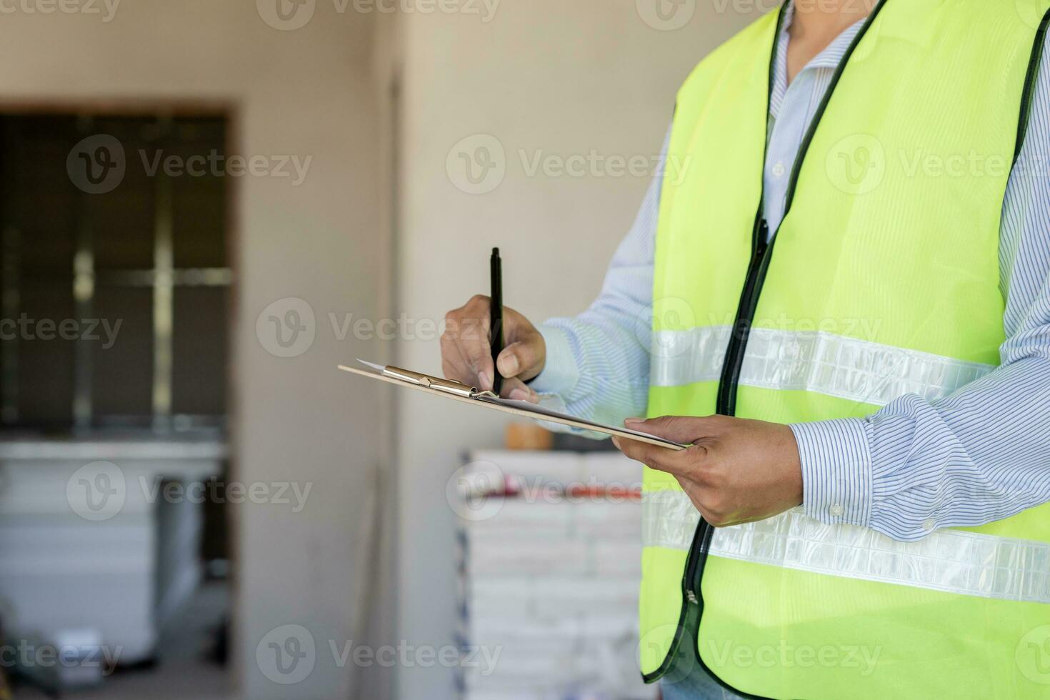 inspector or engineer is inspecting construction and quality assurance new house using a checklist. Engineers or architects or contactor work to build the house before handing it over to the homeowner photo