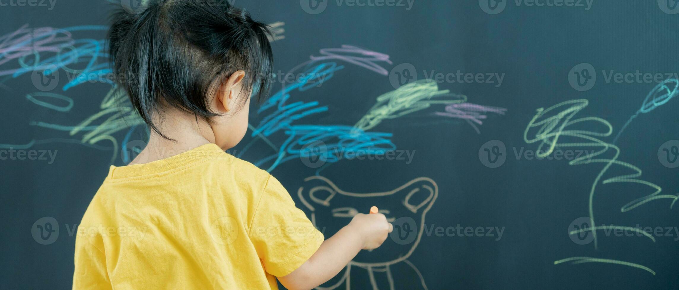 Happy Asia children playing learning paint on black board. Activity, development, IQ, EQ, meditation, brain, muscles, essential skills, family having fun spending time together. Holiday photo