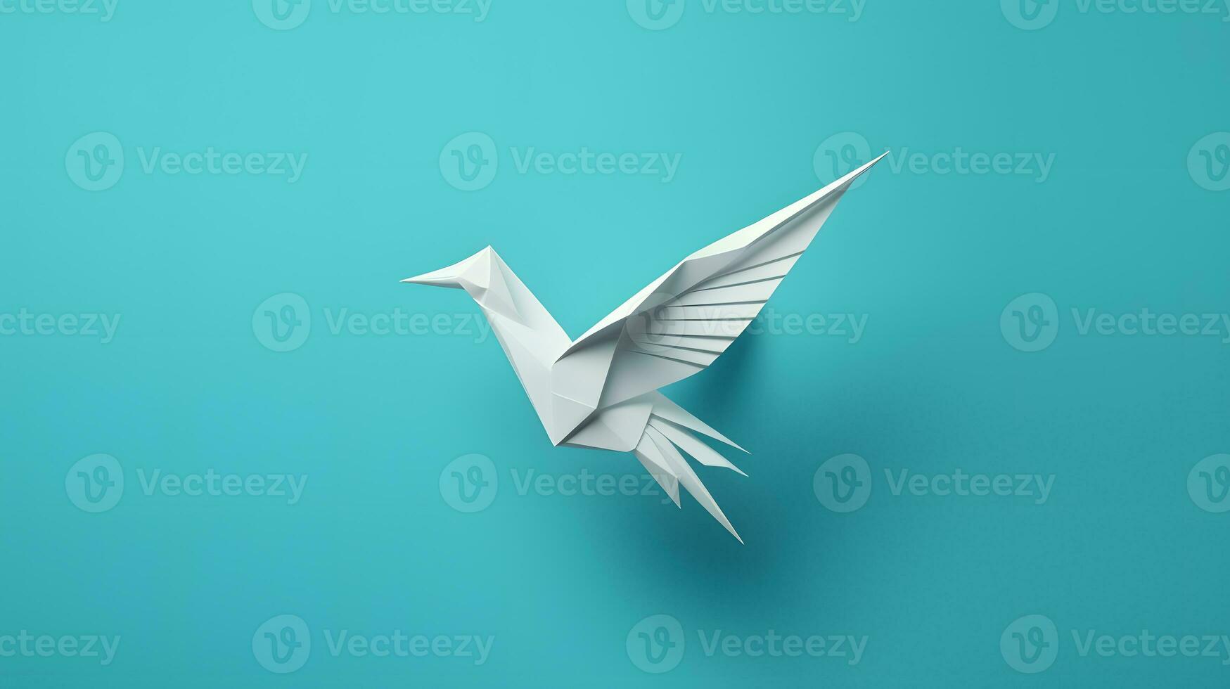 Paper origami bird isolated on blue background photo