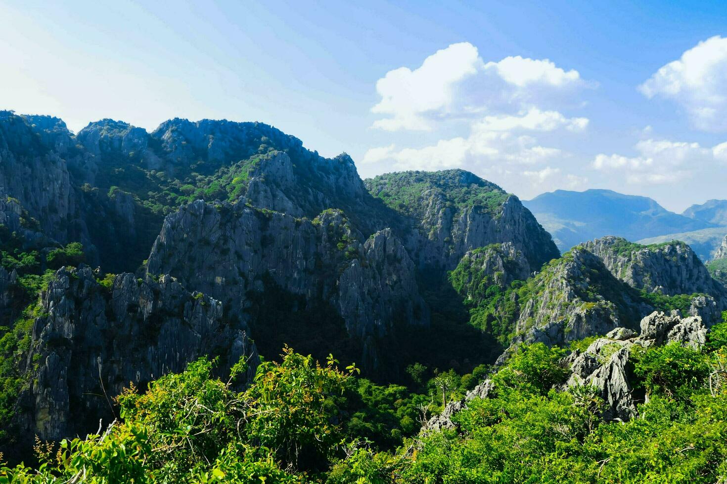 Aerial panorama of Thailand's Khao Sam Roi Yot National Park, there is a well-known tourist destination with views of the sea, limestone mountain, and a farm. photo