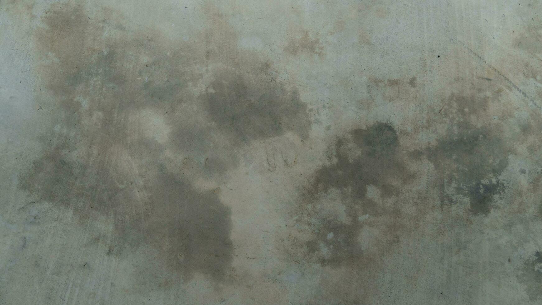 Background and textured above view of cement floor gray color. Cement surface with faint tire marks. Surface of cement floor indoor. photo