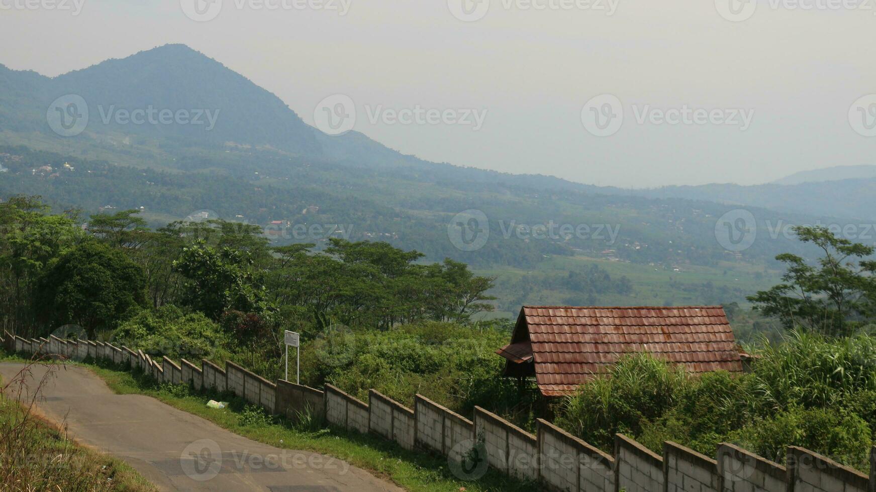 View of a mountain covered in mist and clear clouds photo