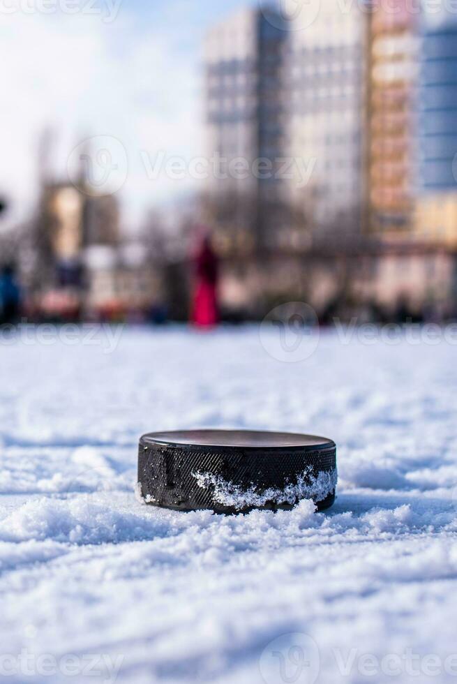 hockey puck lies on the snow macro photo