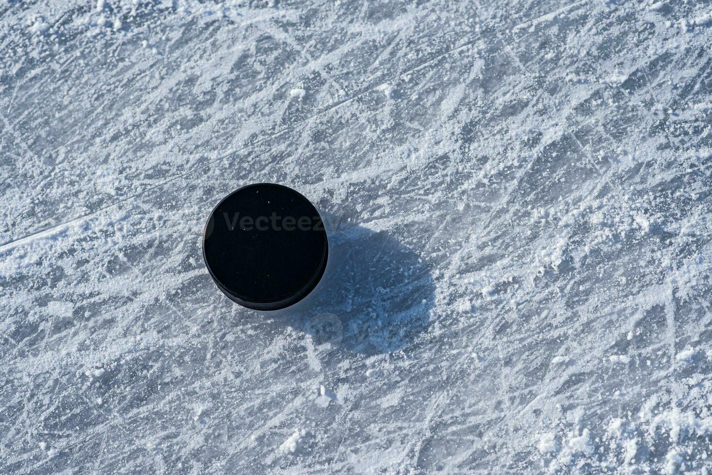 hockey puck lies on the snow close-up photo