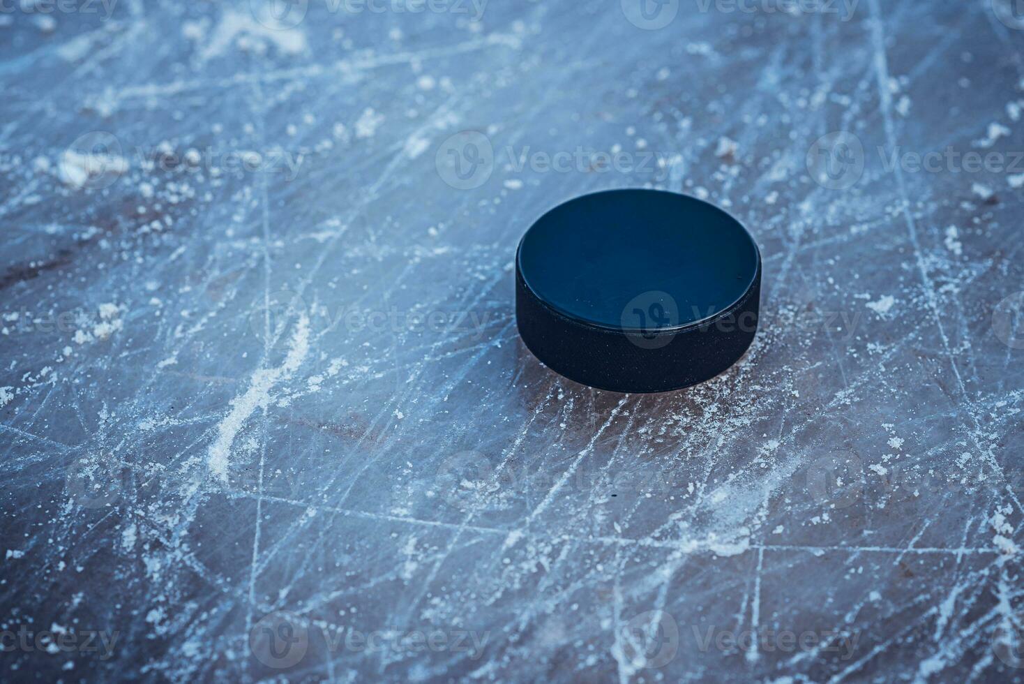 hockey puck lies on the snow macro photo