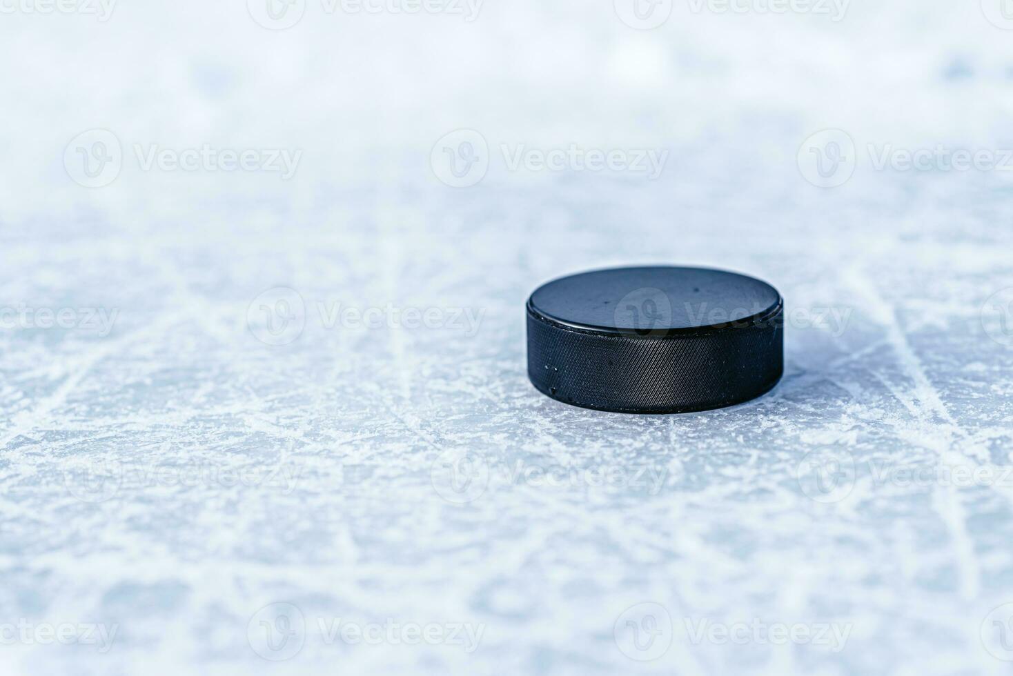 hockey puck lies on the snow close-up photo