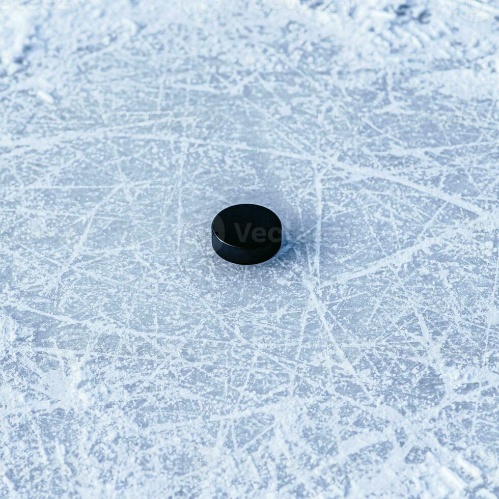 hockey puck lies on the snow close-up photo