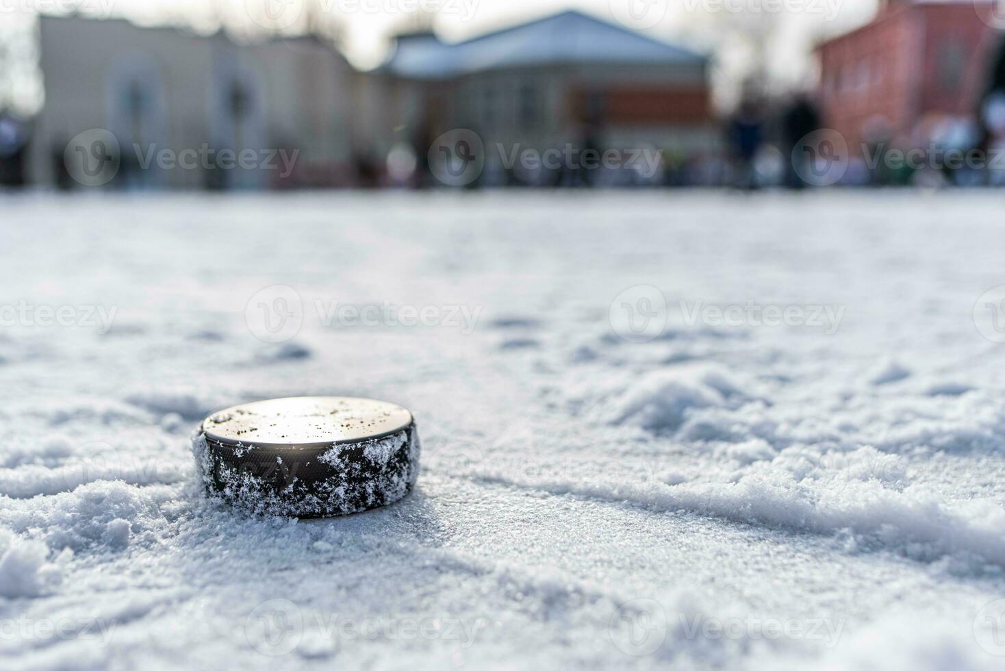 hockey puck lies on the snow macro photo