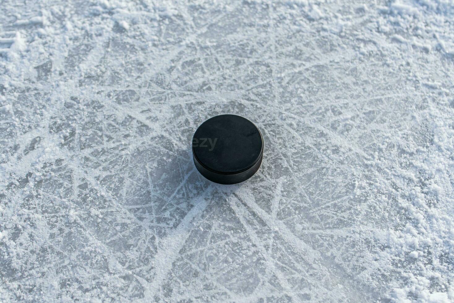 hockey puck lies on the snow close-up photo