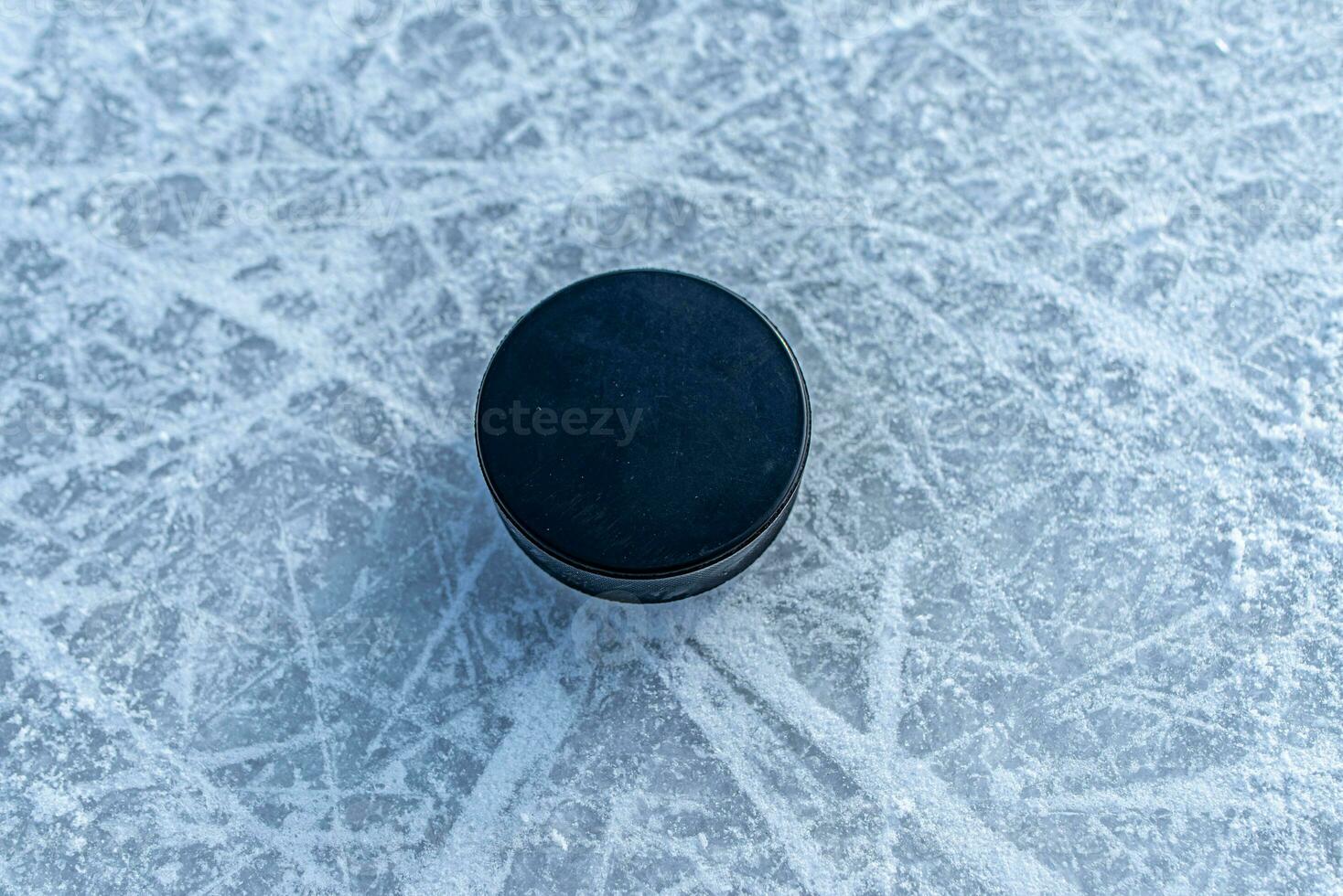 hockey puck lies on the snow close-up photo