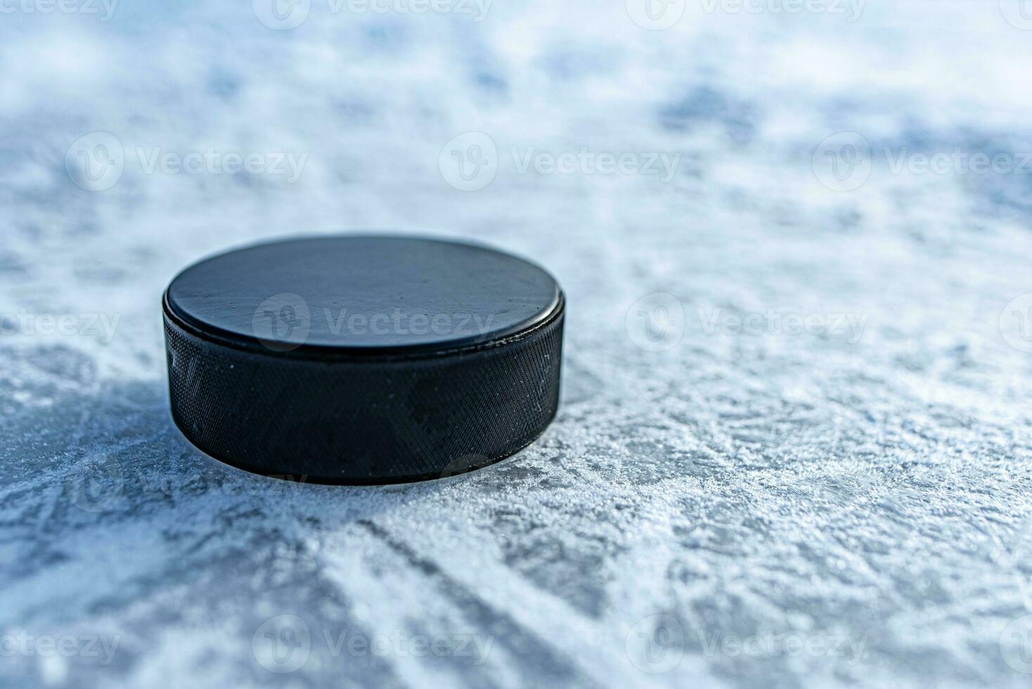 hockey puck lies on the snow close-up photo