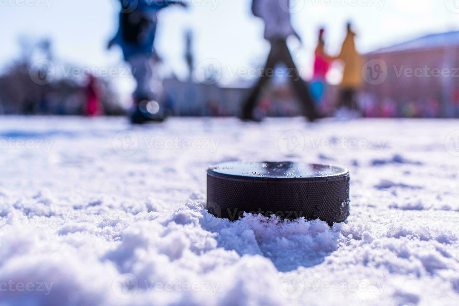 hockey puck lies on the snow macro photo