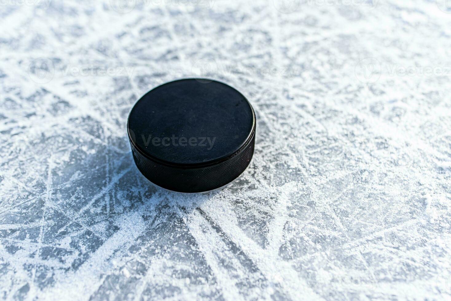 hockey puck lies on the snow close-up photo