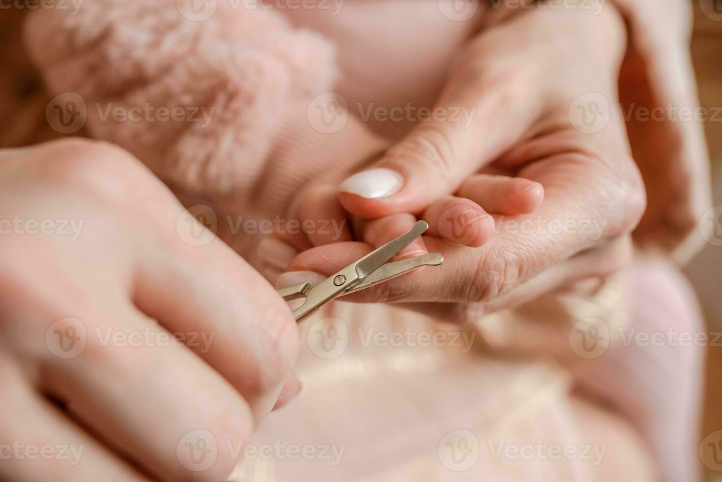 Mom cut the child's nails at home photo