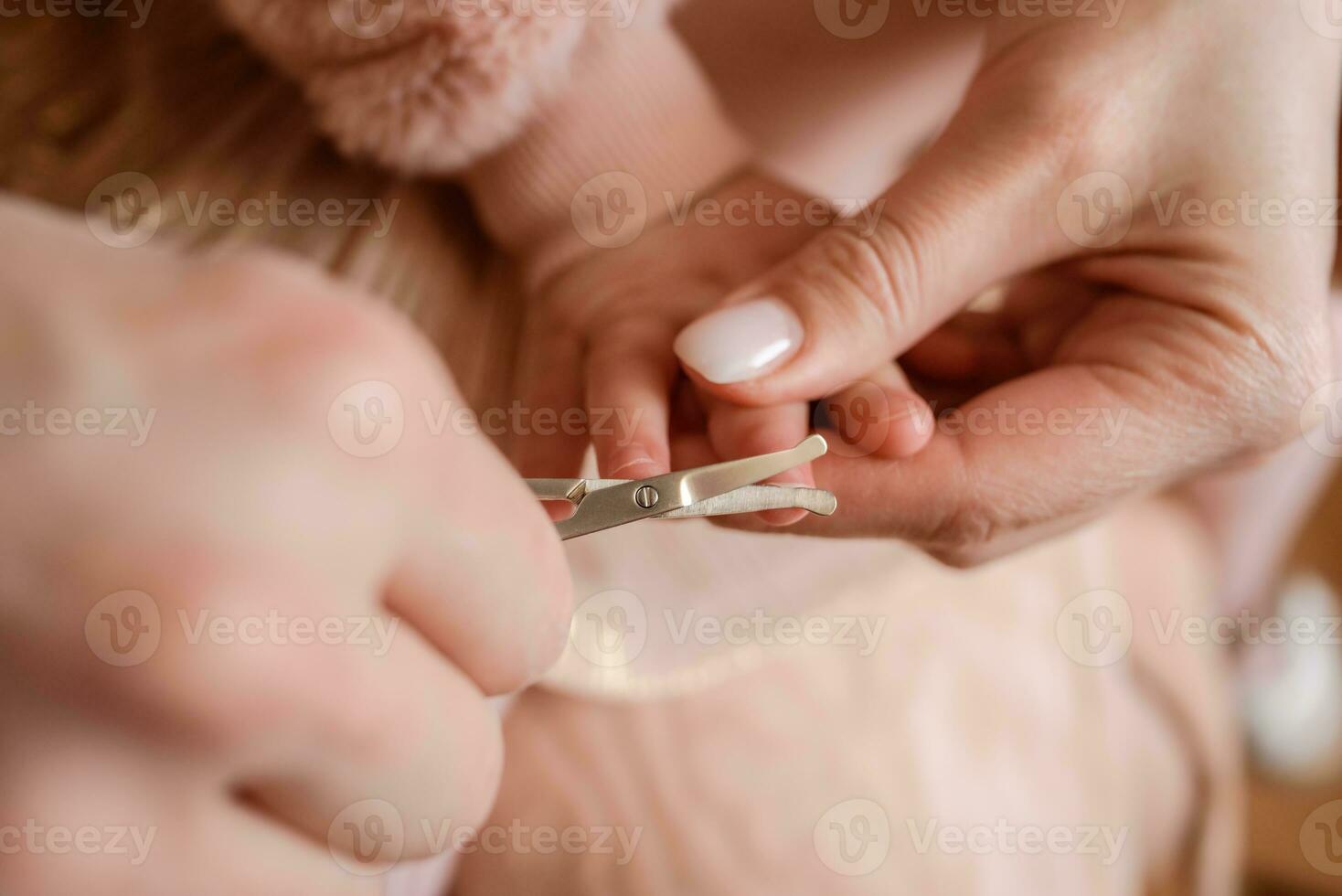 Mom cut the child's nails at home photo