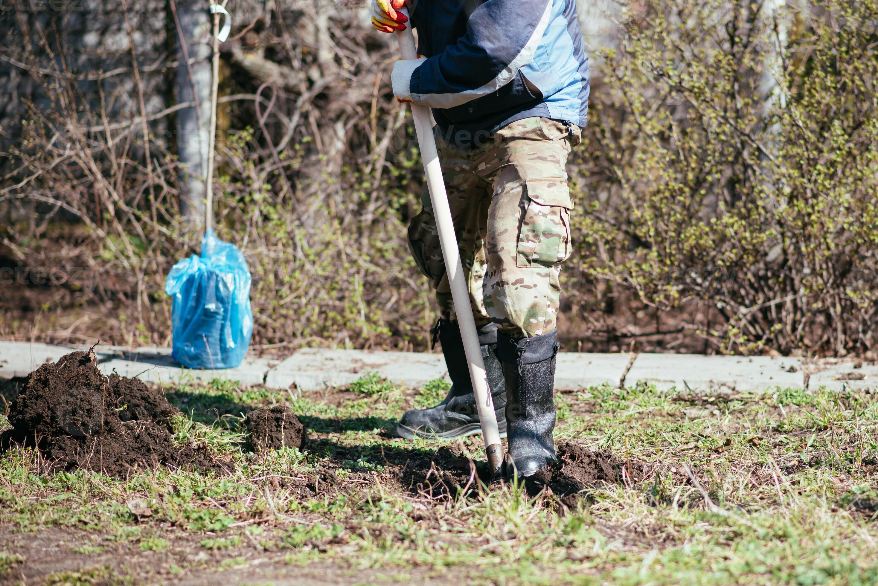 father and son digging ground in forest with shovels, ecology