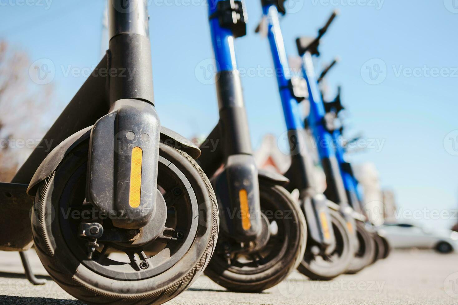 Electric scooters are parked in the city center. Modern public mobile transport photo