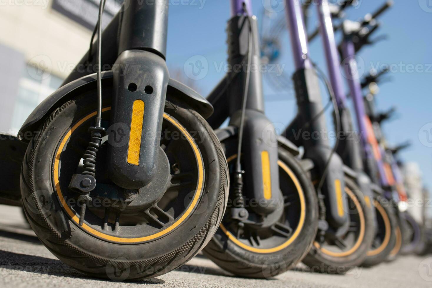 Electric scooters are parked in the city center. Modern public mobile transport photo