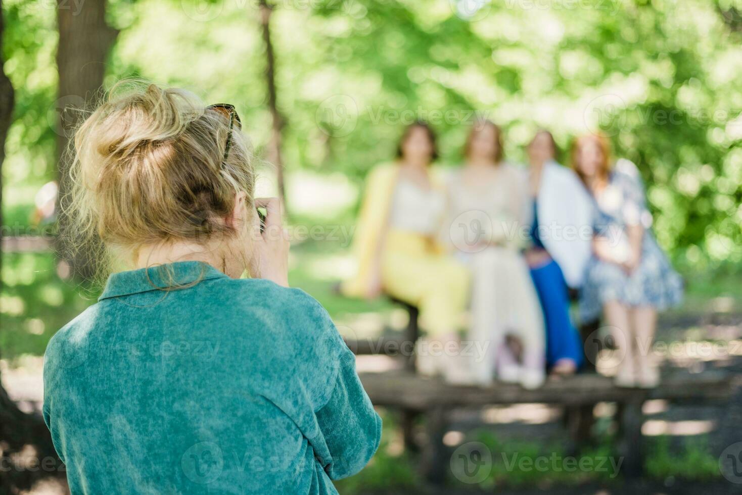 The wedding photographer photographs the guests of the bride and groom in nature photo