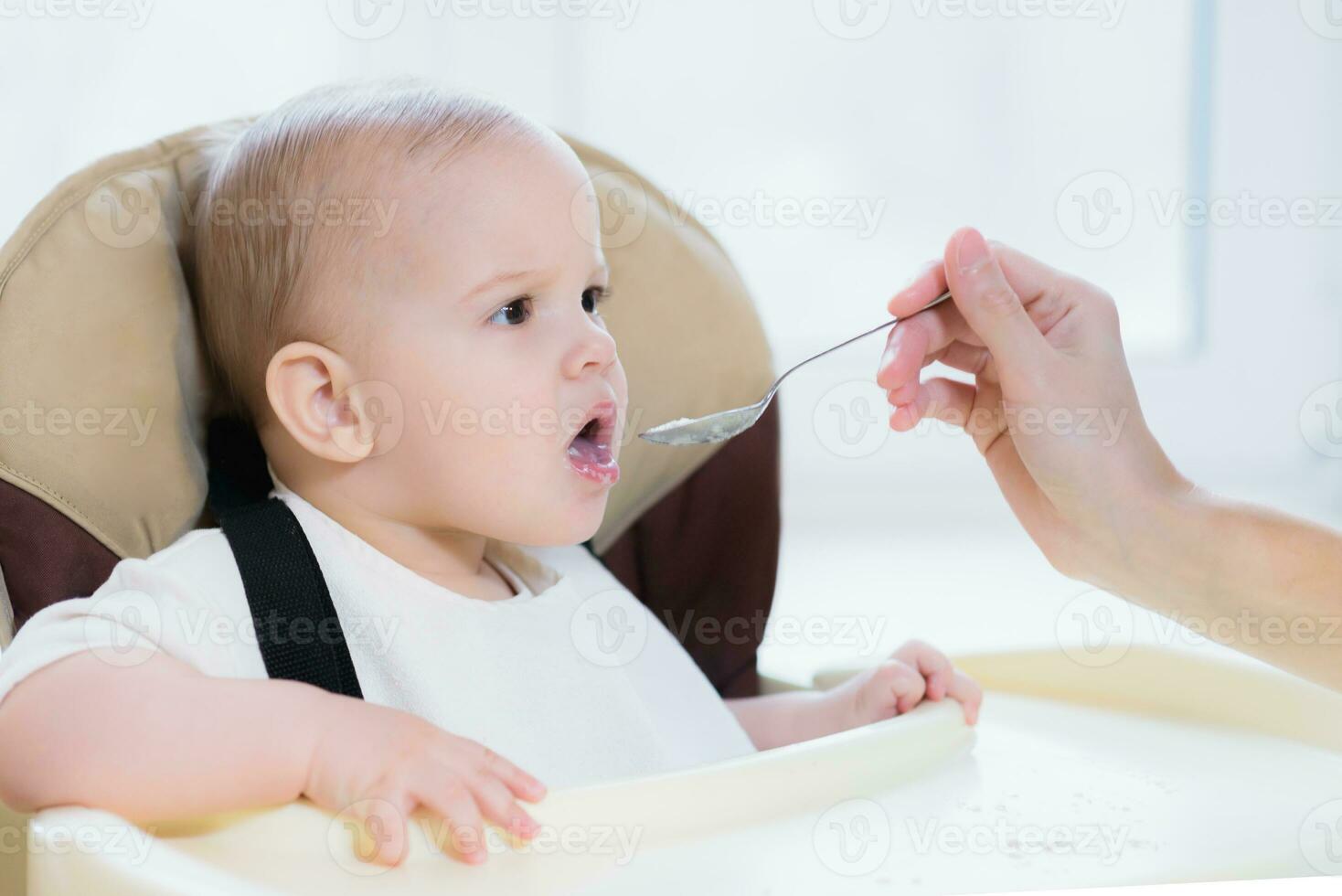 Mom feeds her nine months baby at home photo