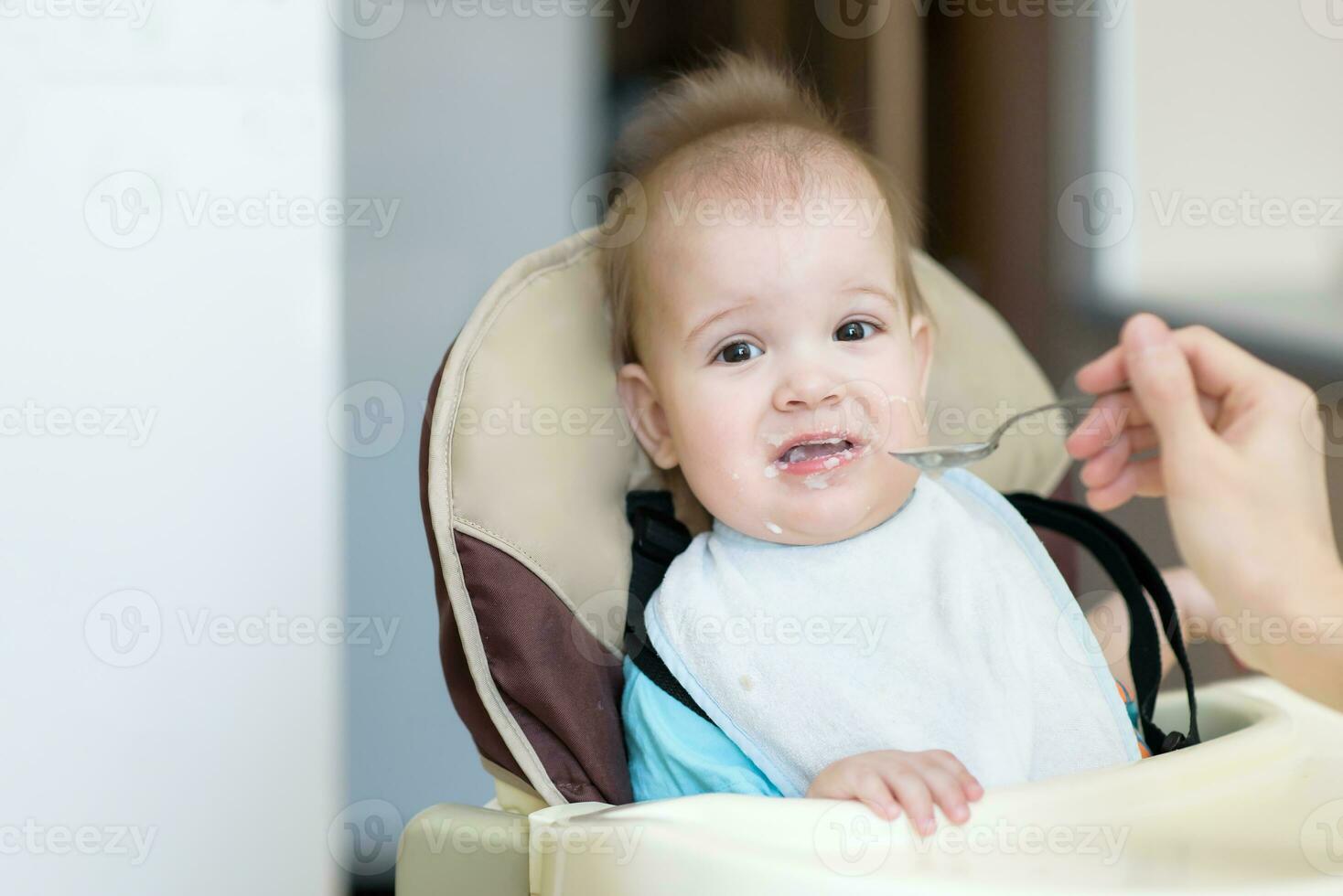 Mom feeds the baby who is naughty photo