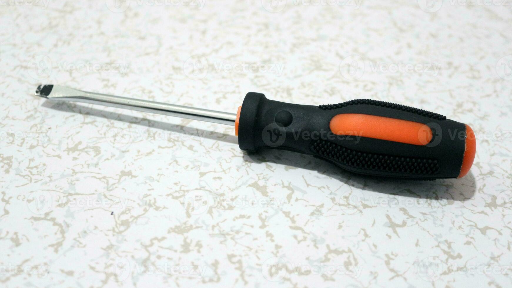Close-up of an orange screwdriver photo