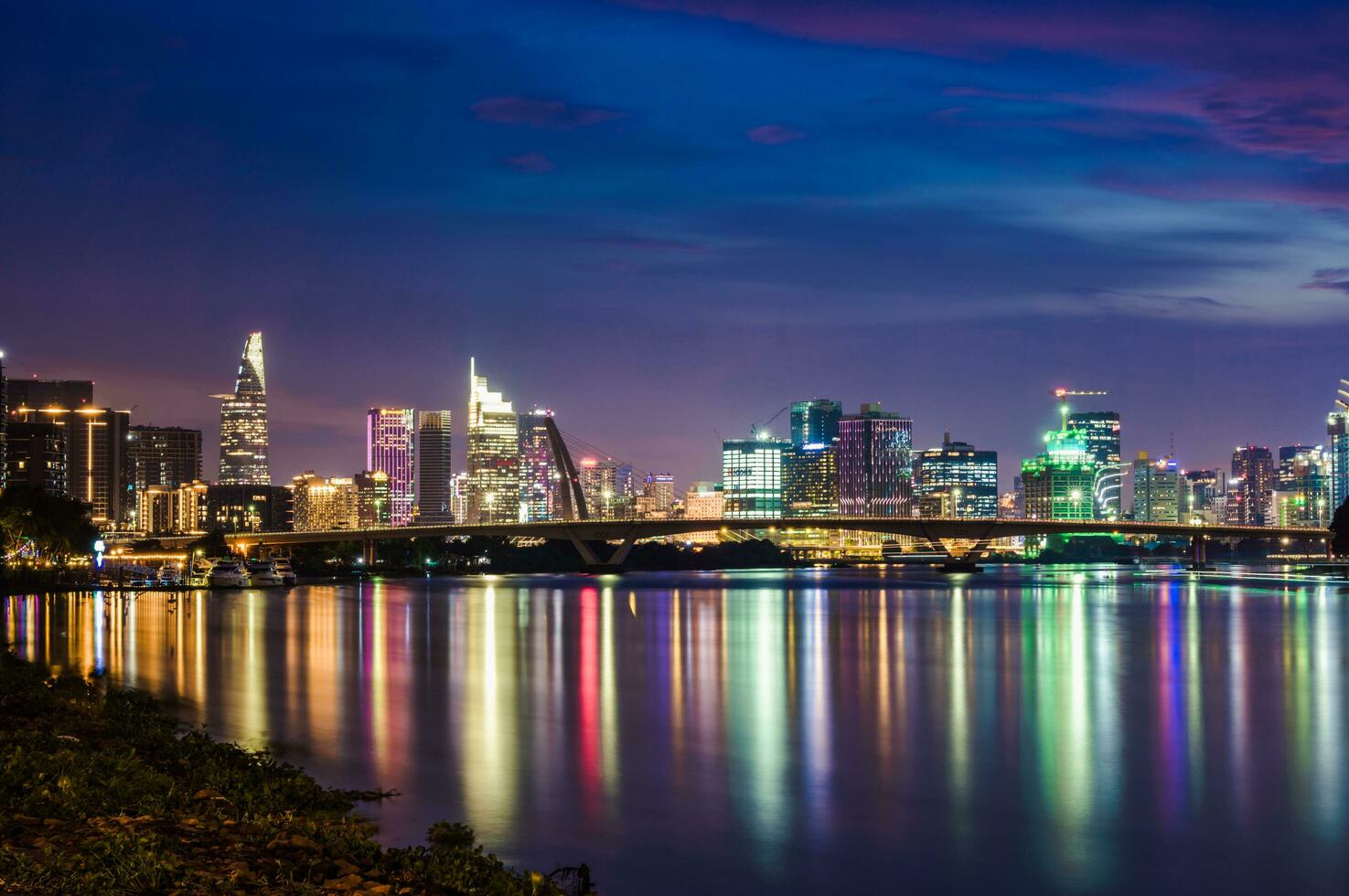 Ho Chi Minh, Viet Nam - 12 July 2023 Ho Chi Minh City skyline and the Saigon River at sunset.  It is a popular tourist destination of Vietnam. photo