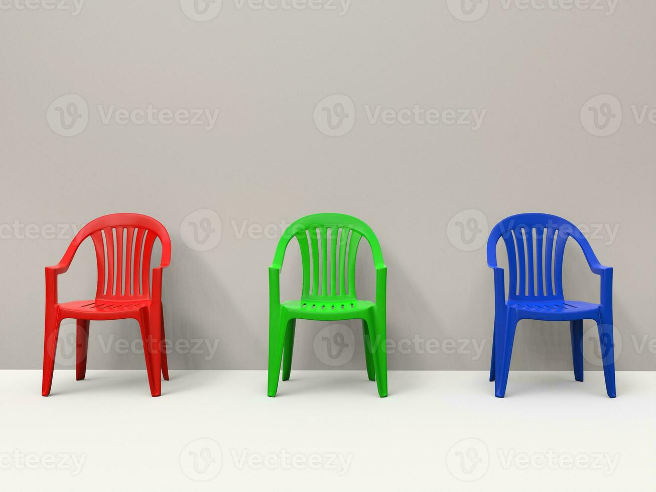 Red, green and blue generic plastic chairs against a wall photo