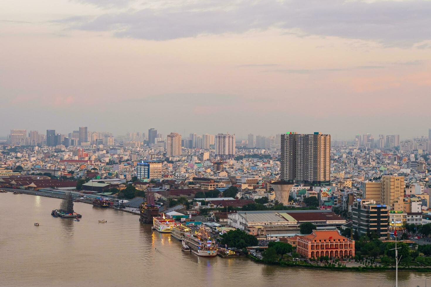 Ho Chi Minh City, Viet Nam 5 August 2023 sunset at District 1,  aerial view of Bach Dang habor. Traffic in city photo