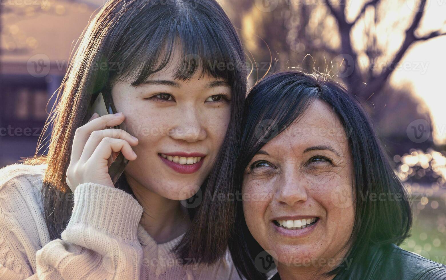 portrait of multi-ethnic co-worker couple talking on the smartphone photo