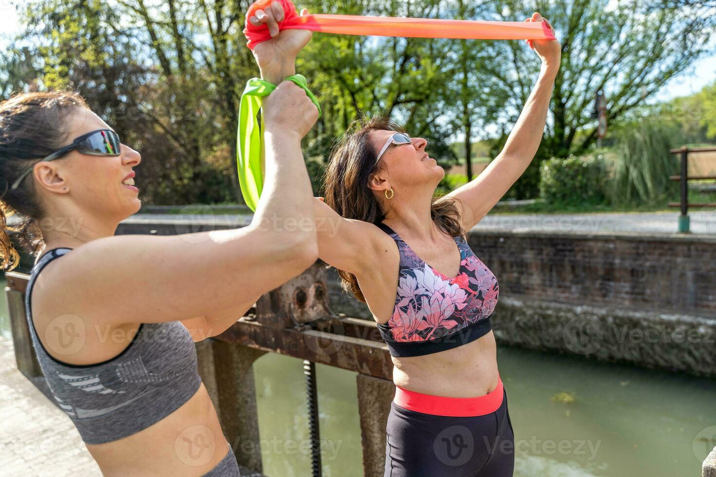 beautiful mature women doing exercises outdoors with a resistance band photo