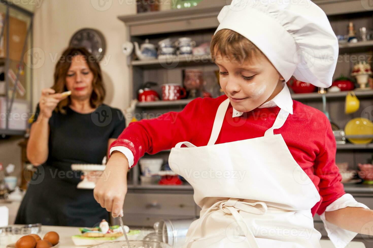 Mom and son cooking sweet biscuits photo