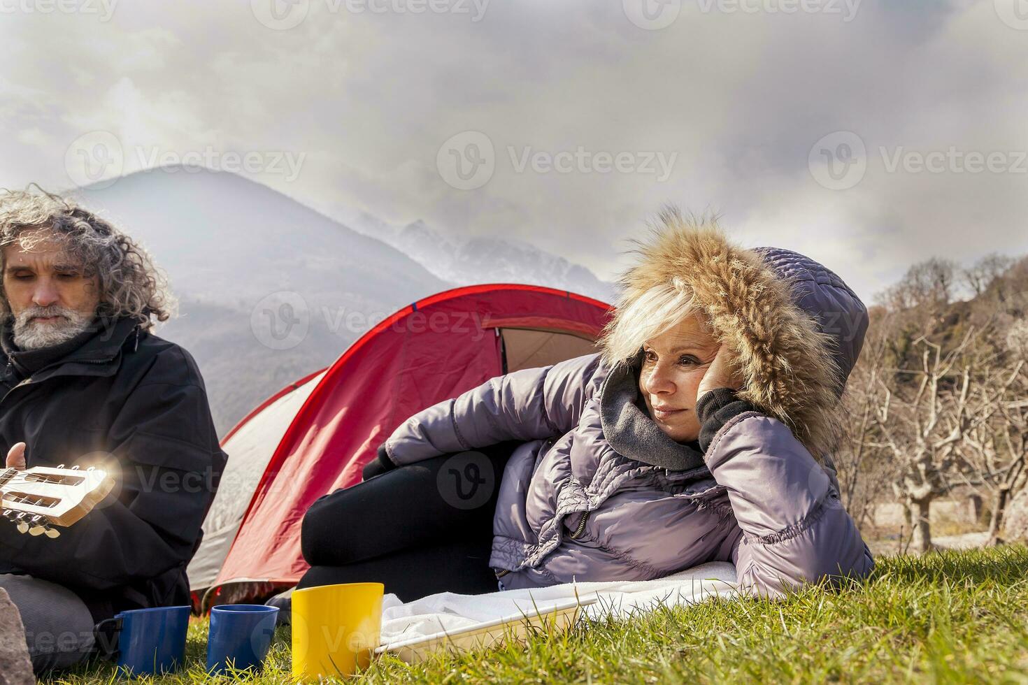 beautiful mature couple relaxing and cooking eggs photo