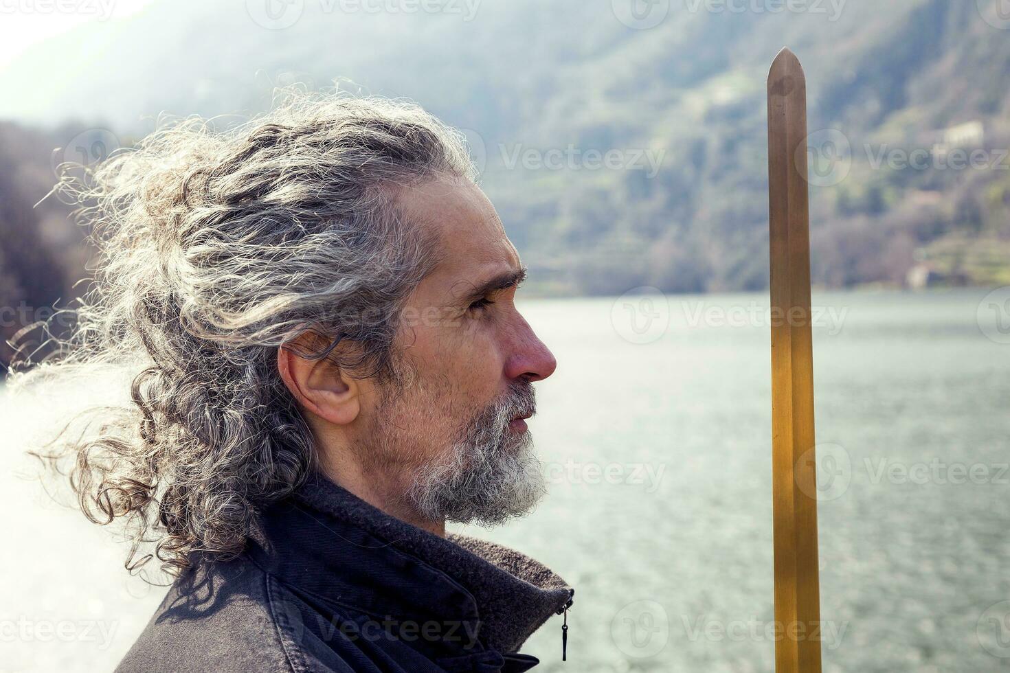 mature man practicing Tai Chi discipline outdoors photo