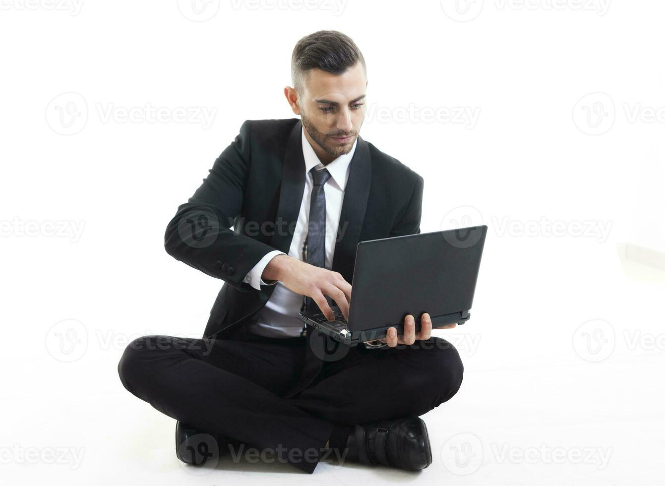 portrait of young businessman with laptop isolated on white background photo