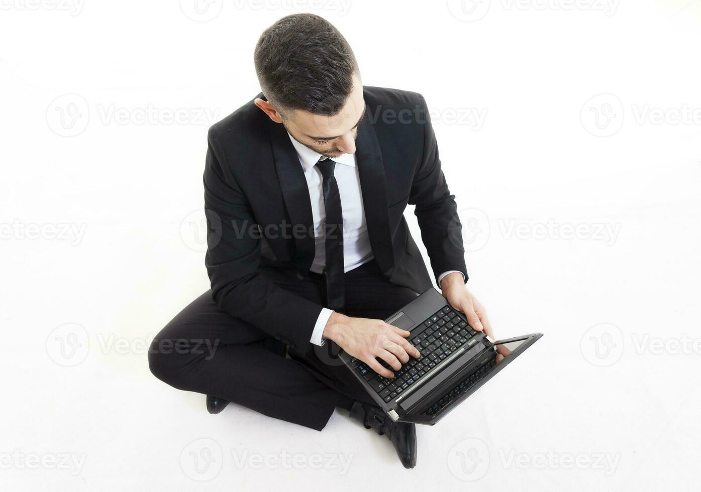 portrait of young businessman with laptop isolated on white background photo