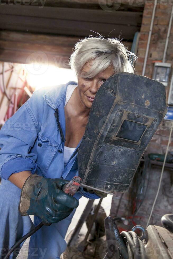 beautiful lady at work in his old workshop photo