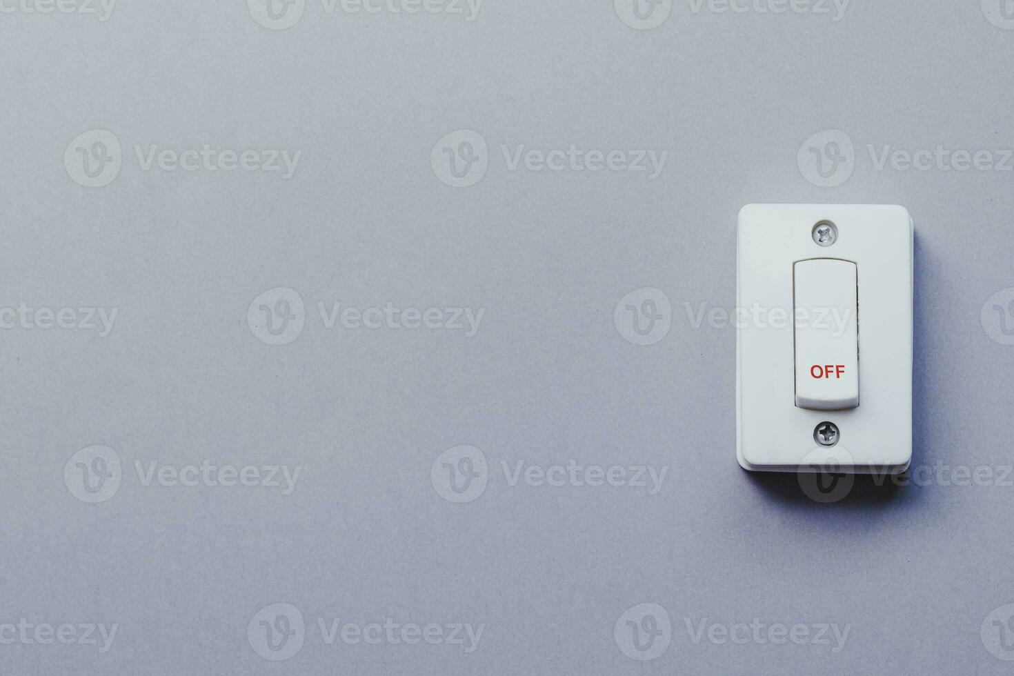 Light switch on grey wall. On and Off switch. Saving energy concept photo