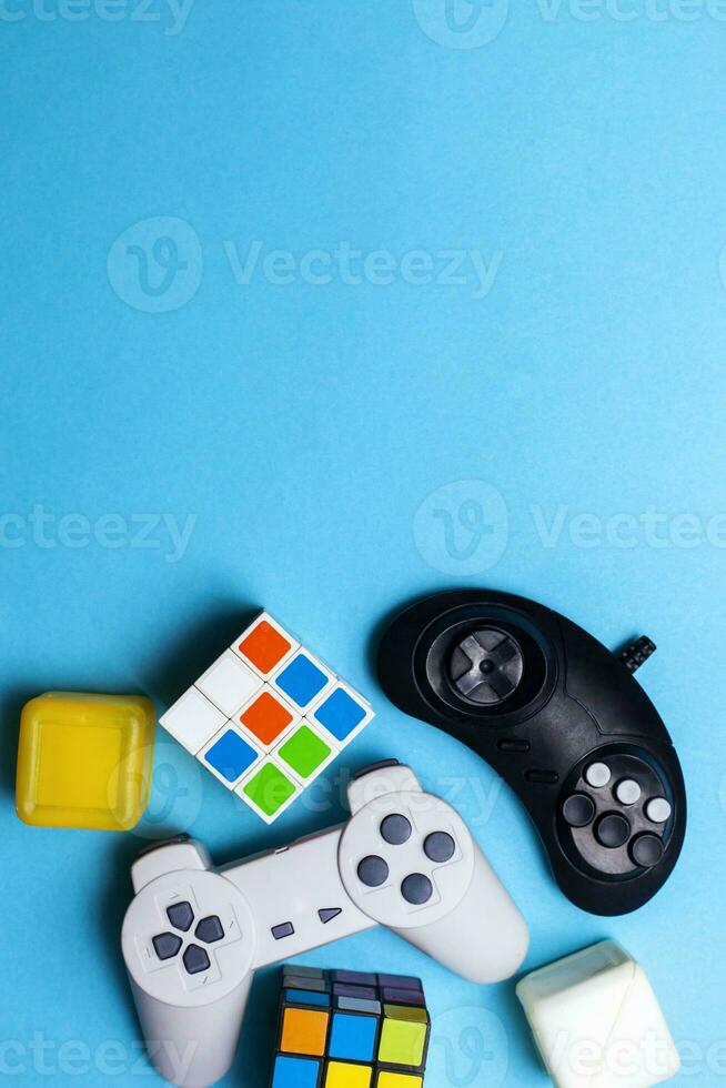 Gaming background. Video console and board games elements on bright blue background. Miscellaneous gaming pieces photo