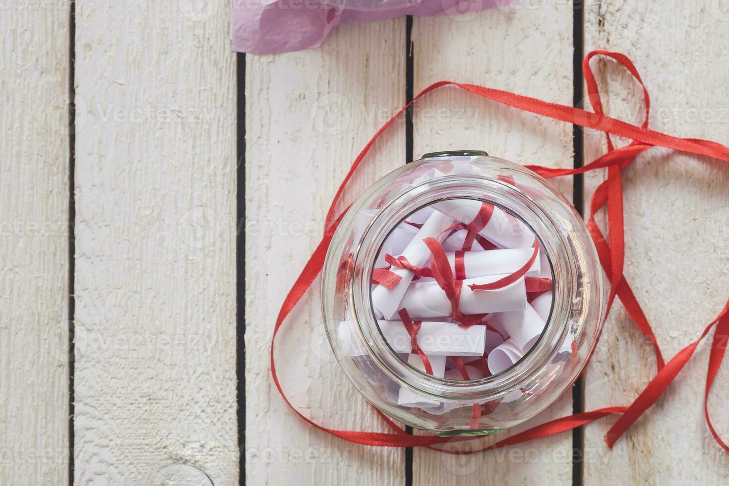 Valentine's day concept. Opened Date Jar with desires on wood photo