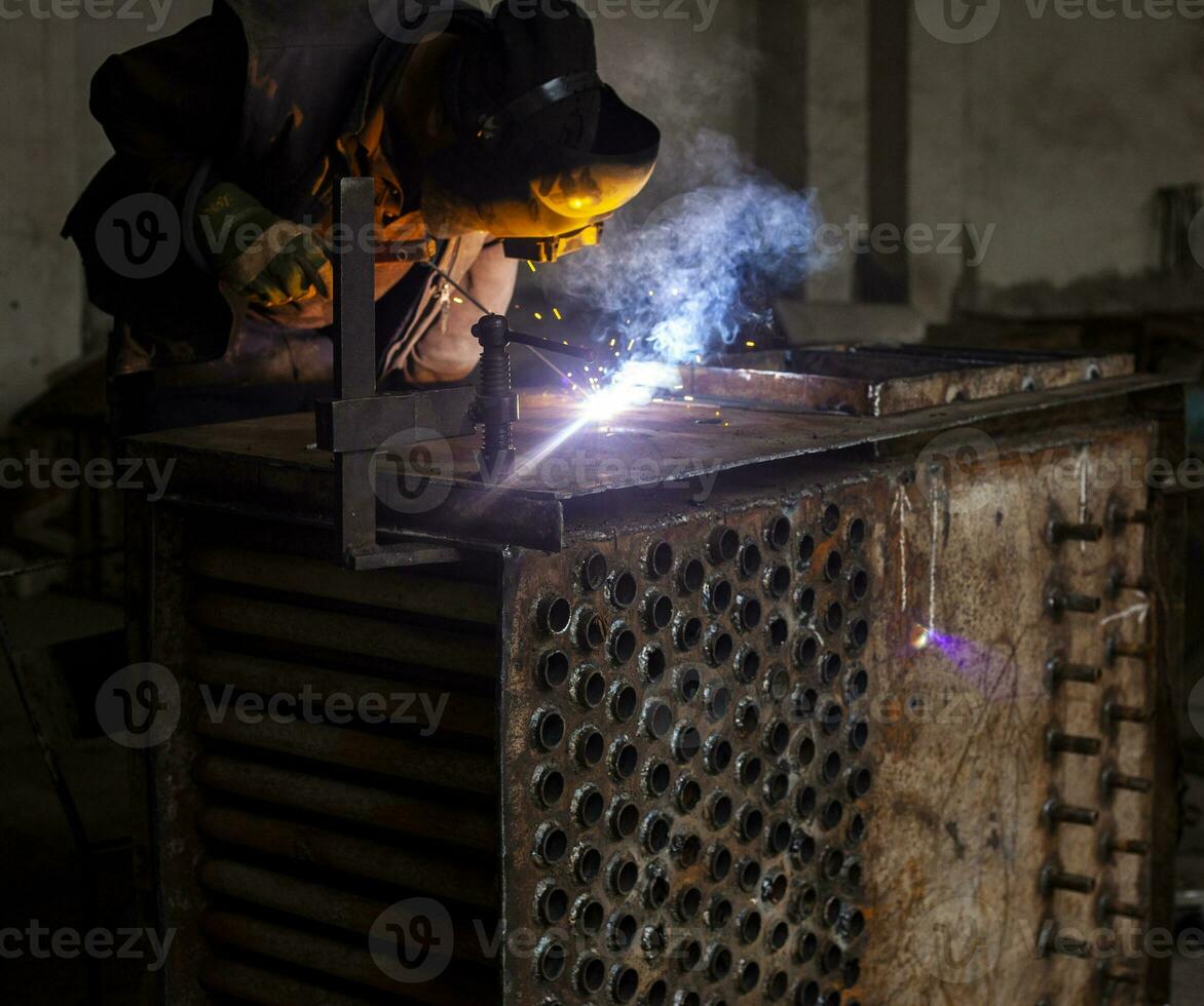 Welder working with metal photo