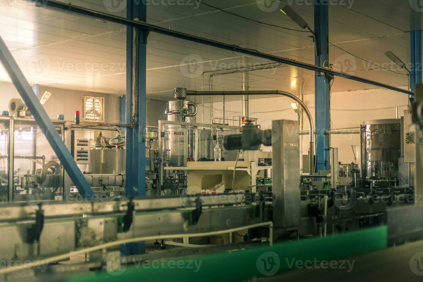 Glass bottles on the automatic conveyor line at the champagne, beer or wine factory. Plant for bottling alcoholic beverages. photo