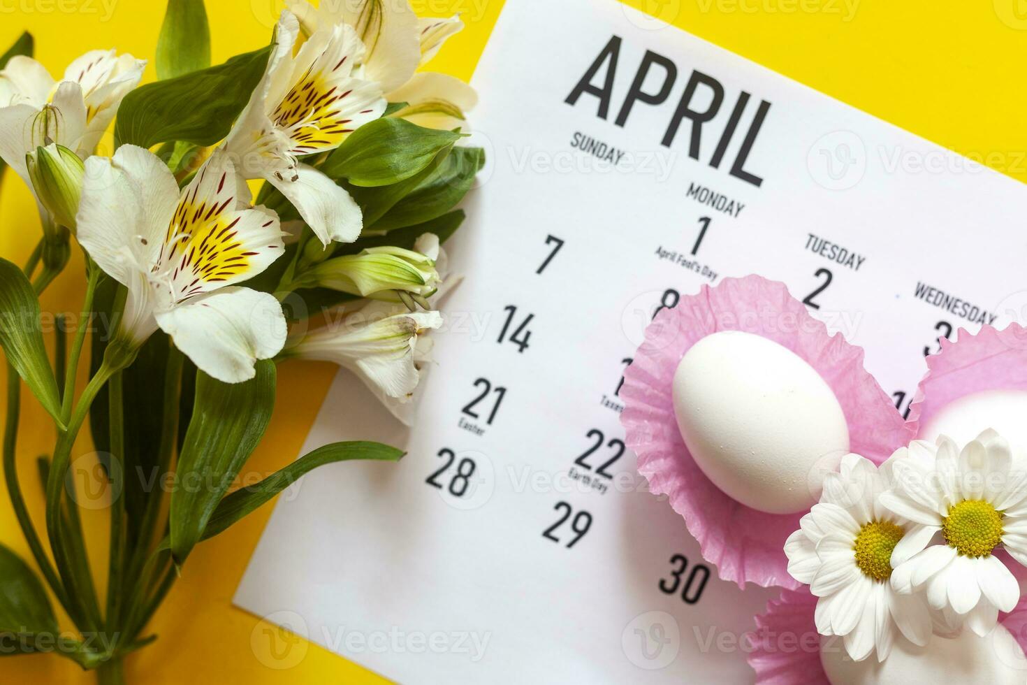 April 2020 Easter monthly calendar with colorful eggs and spring flowers photo