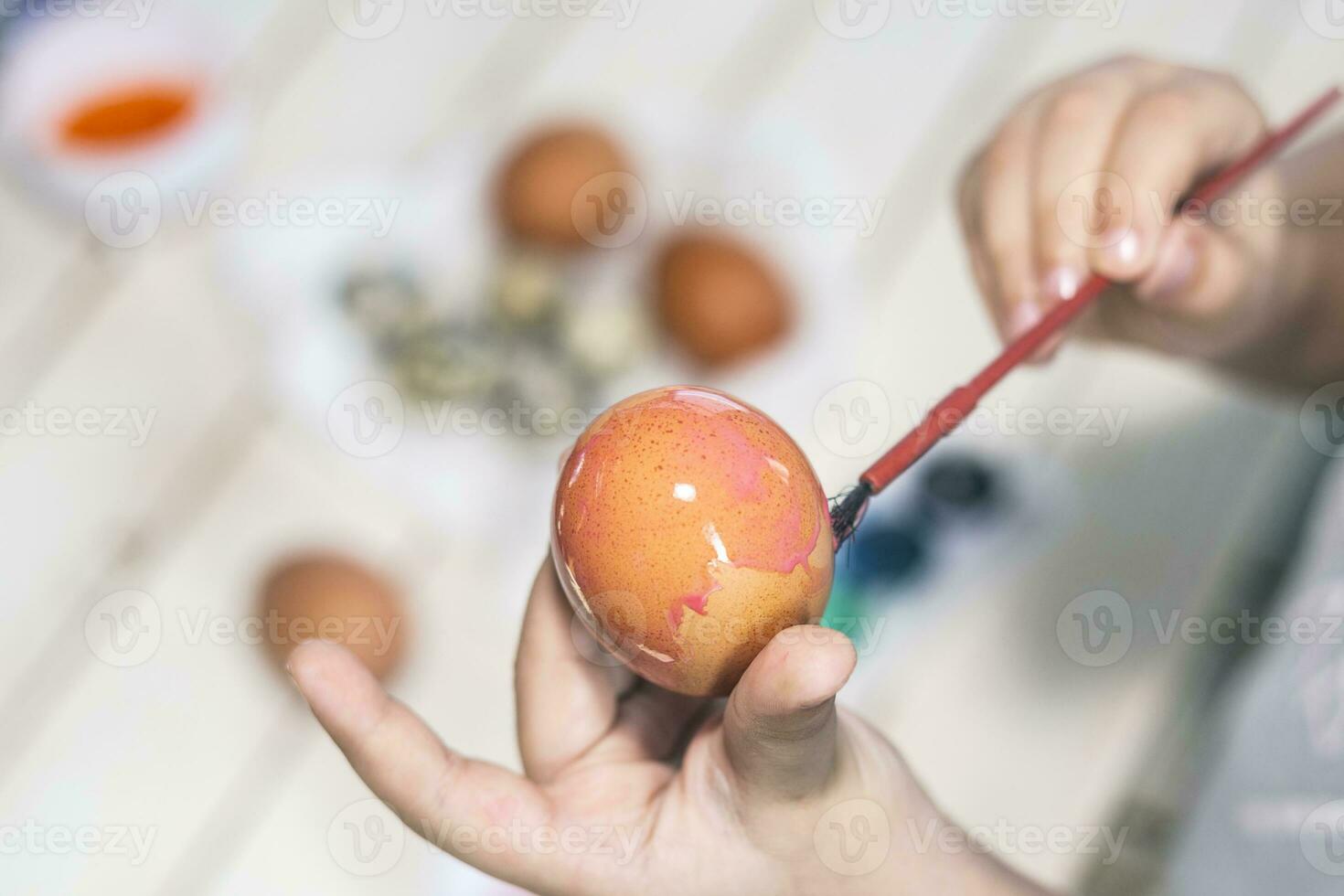 Little boy painting easter eggs photo