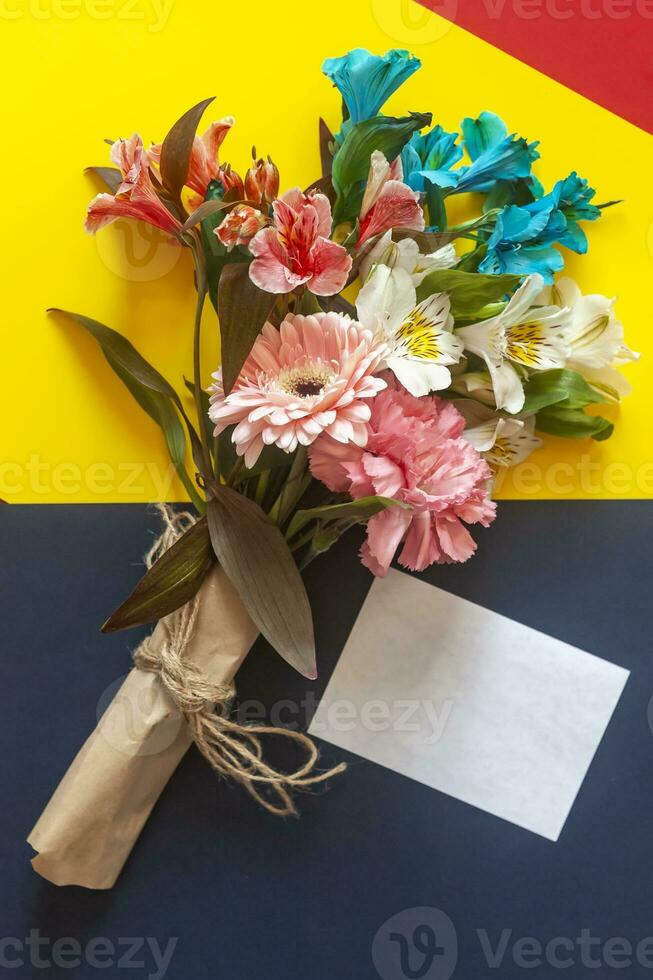 Bouquet of flowers with a card photo