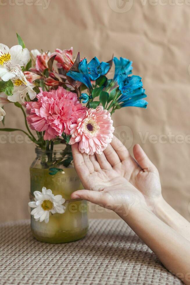 Woman touching colorful spring flowers photo