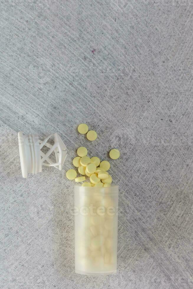 Yellow tablets on the marble photo